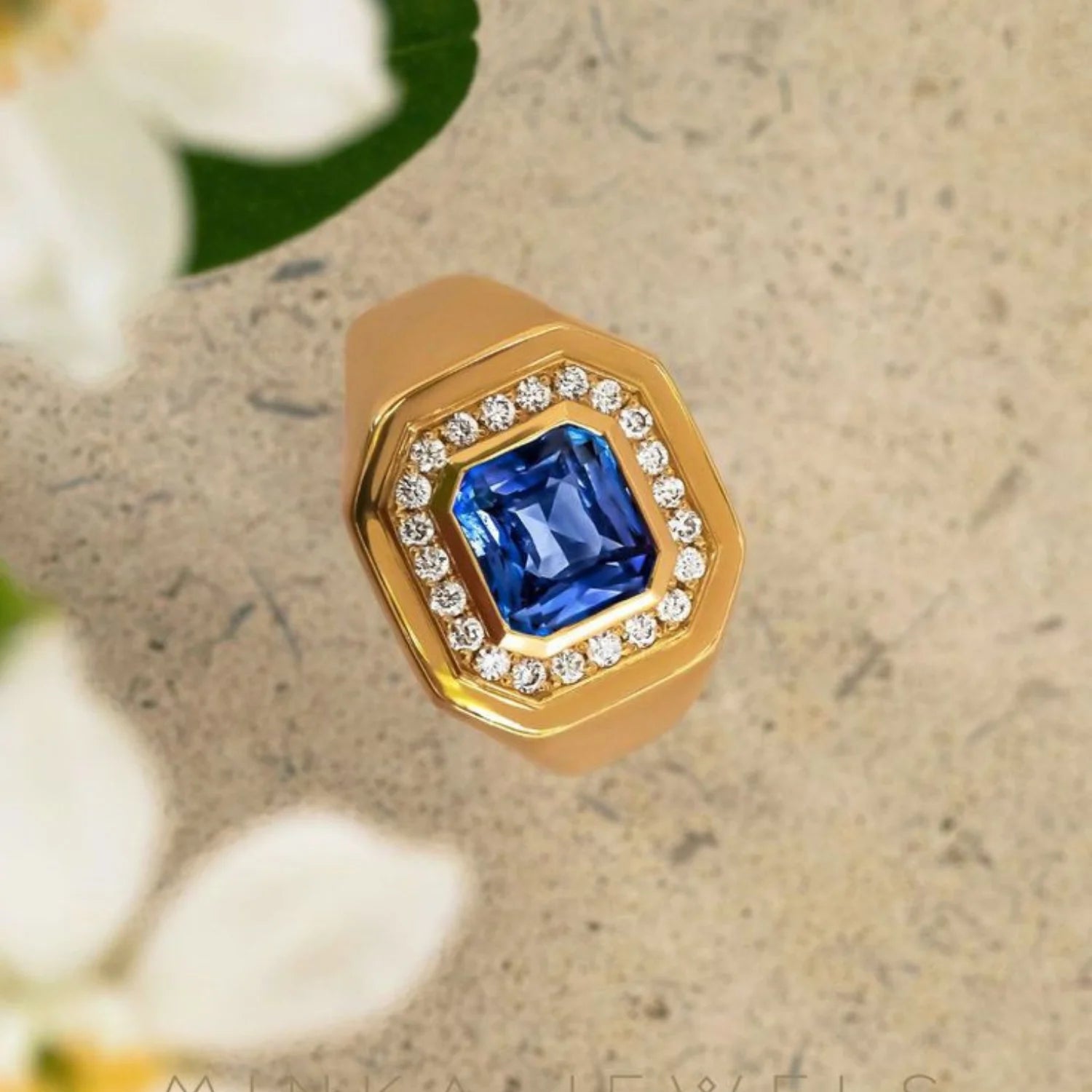 Close-up of Berlin Nights Blue Sapphire Ring showing 2.91ct square octagonal-cut sapphire and 0.35ct diamond halo in 18k gold.
