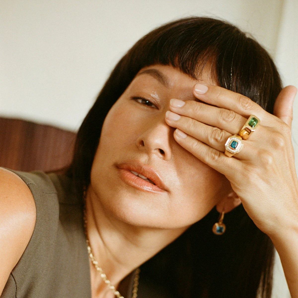 Model wearing Berlin Nights Indicolite Tourmaline Ring on hand, 18k gold, 2.98ct square octagonal-cut tourmaline, diamond halo.
