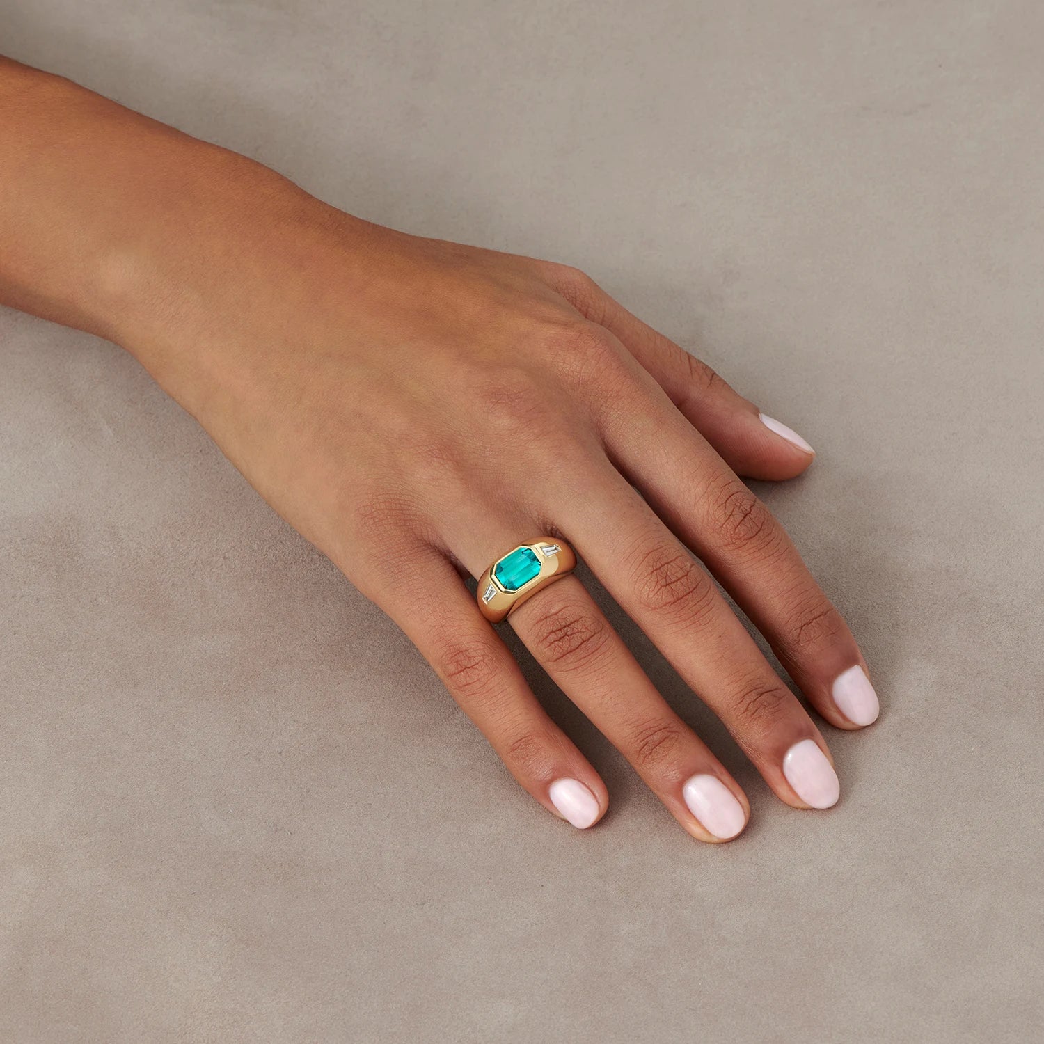Hand model wearing Berlin Gypsy Teal Tourmaline Ring, 18k gold with 3.00ct emerald-cut tourmaline and baguette diamonds.