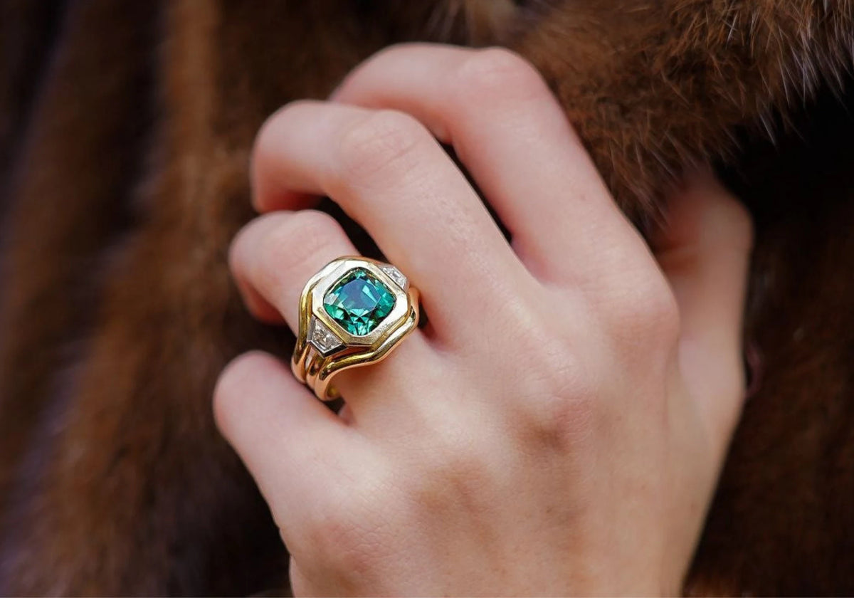 Hand model wearing Berlin Nights 5.96ct green tourmaline ring in 18k yellow gold and platinum with geometric-cut gemstone and diamonds