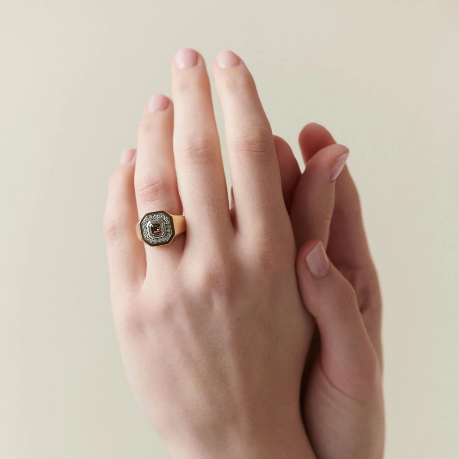 Hand model wearing Berlin Nights Cognac Brown Diamond Ring in 18k yellow gold with 1.24ct octagonal cognac brown diamond and 0.54ct halo diamonds
