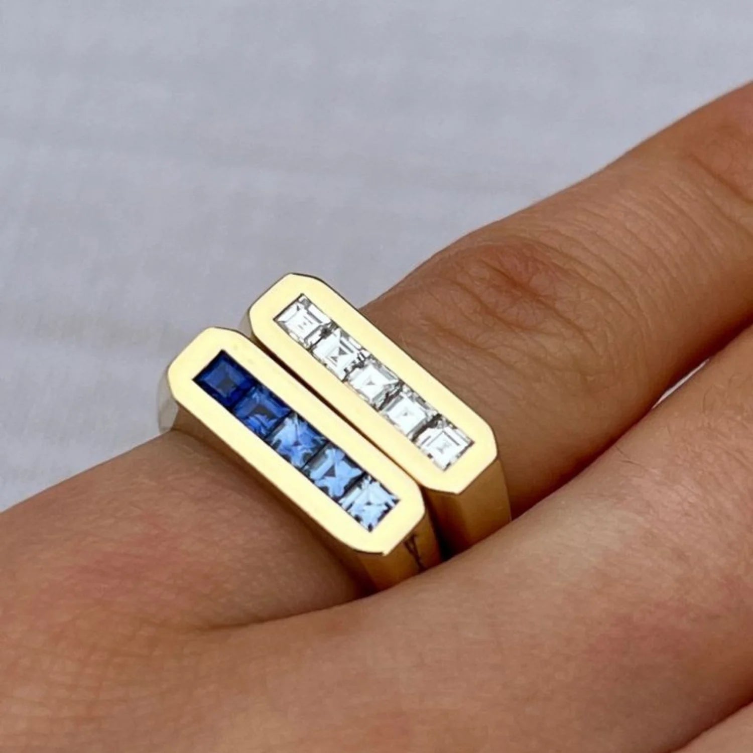 Close-up of Ley Lines Blue Sapphire Ombre Pinky Ring showing five princess-cut blue sapphires totaling 0.95ct in 18k gold stacked with Ley Lines Diamond Pinky Ring