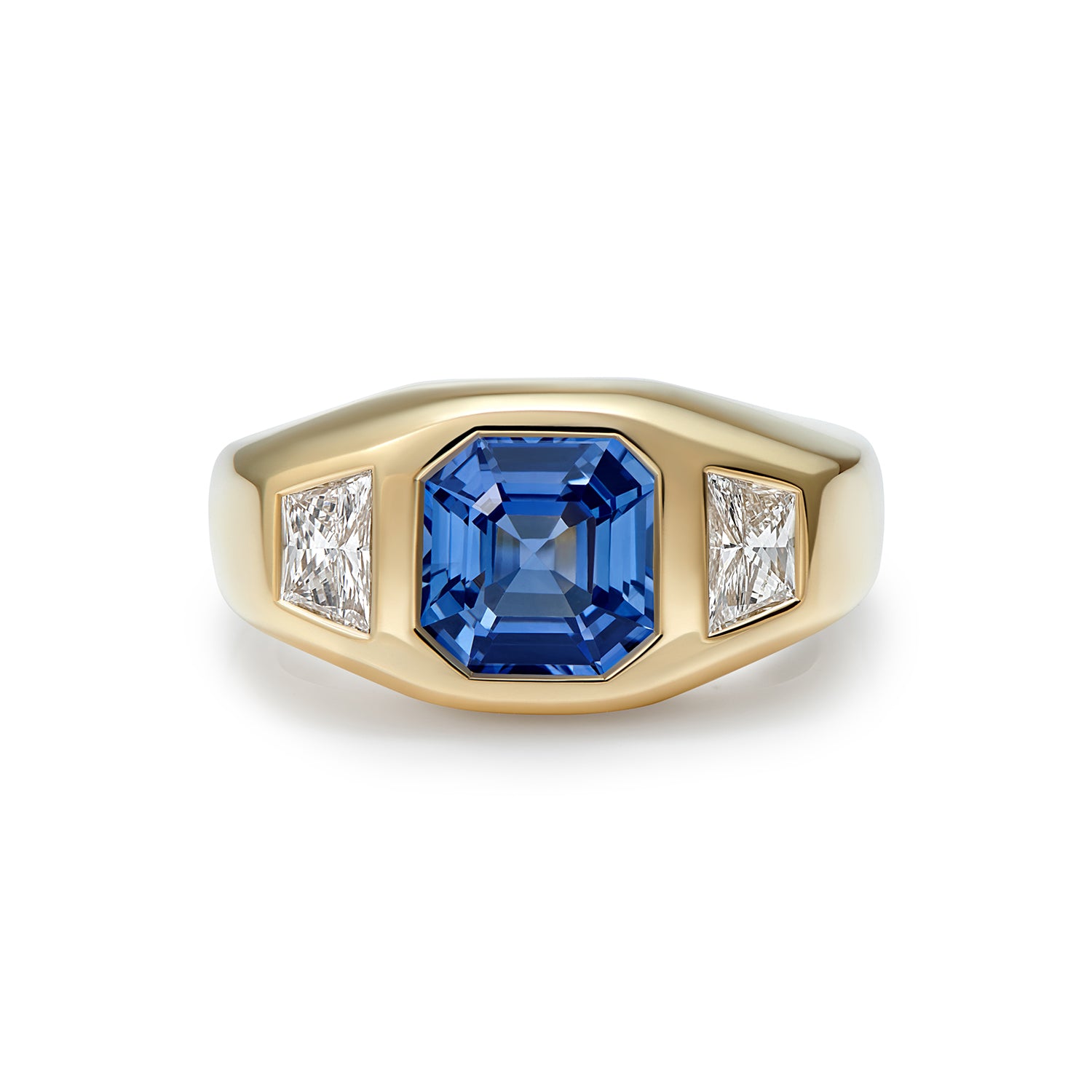 Bridal engagement ring in 18k yellow gold featuring a 2.54ct octagon-cut blue sapphire flanked by 0.50ct trapezoid diamonds