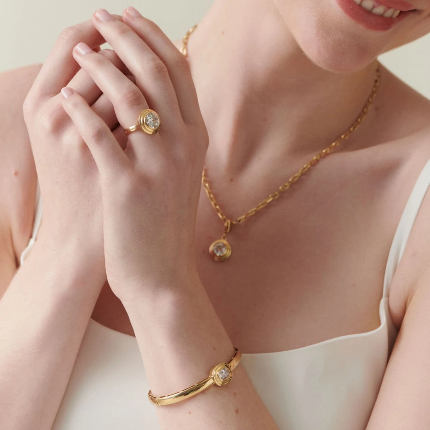 Model wearing Athena collection 3.05ct Old Cut diamond ring in 18k yellow gold, styled with matching Athena Bridal collection jewelry