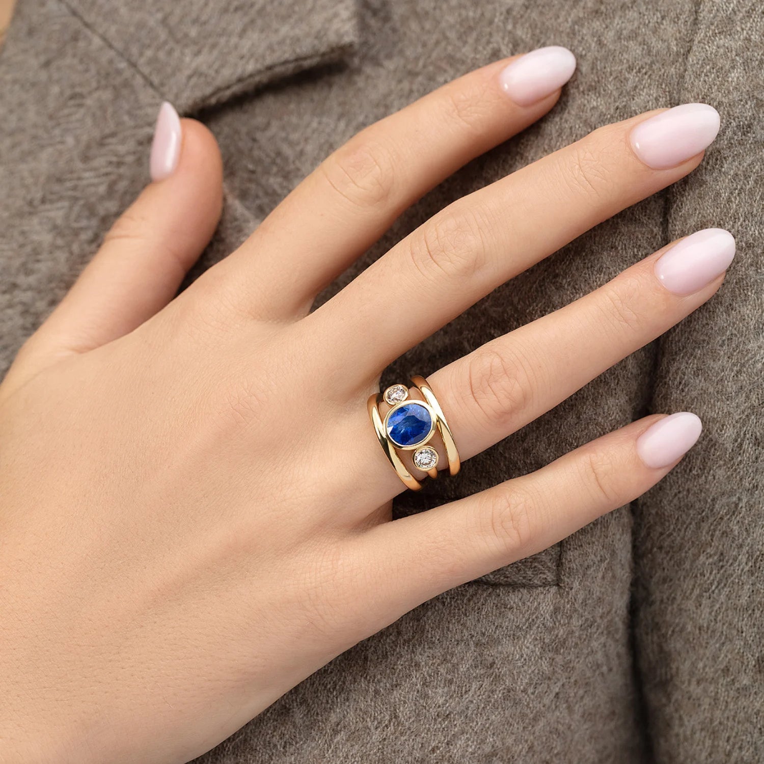 Hand model wearing Les Trois Vallées Cornflower Blue sapphire ring in 18k yellow gold with 3.80ct no-heat Sri Lankan sapphire and 0.72ct diamonds
