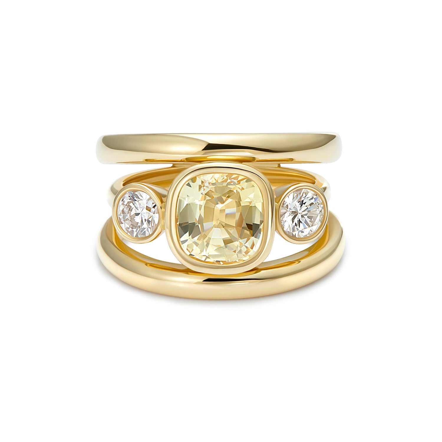 18k yellow gold ring featuring a 3.08ct no-heat Sri Lankan yellow cushion-cut sapphire set between two round white diamonds on a three-band design