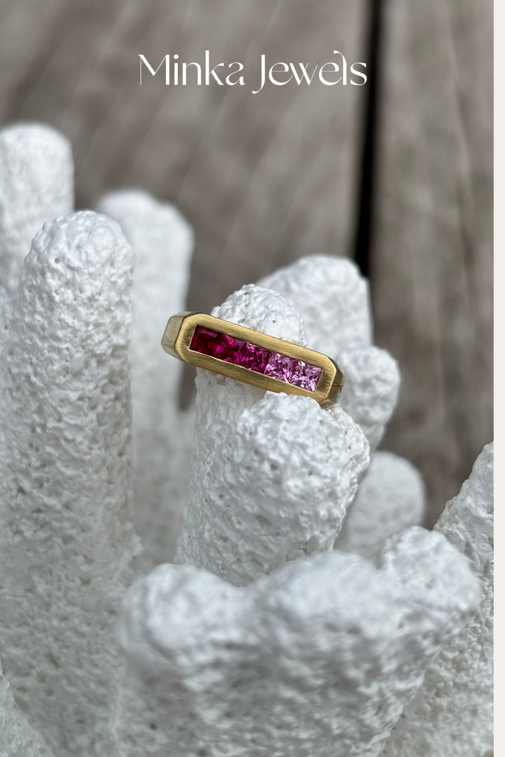 Close-up of 18k yellow gold pinky ring with ombré pink sapphires from Minka Jewels Ley Lines collection