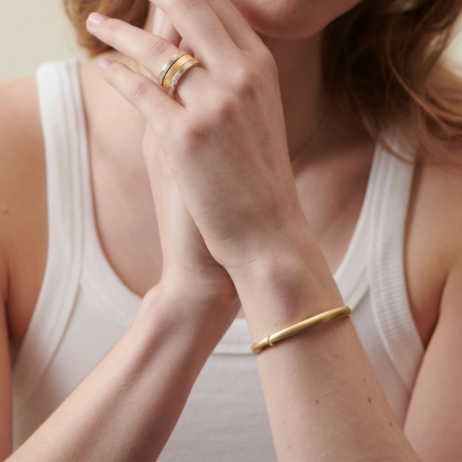 Model wearing Ley Lines brushed gold bracelet in 18k yellow gold with a luxurious brushed finish