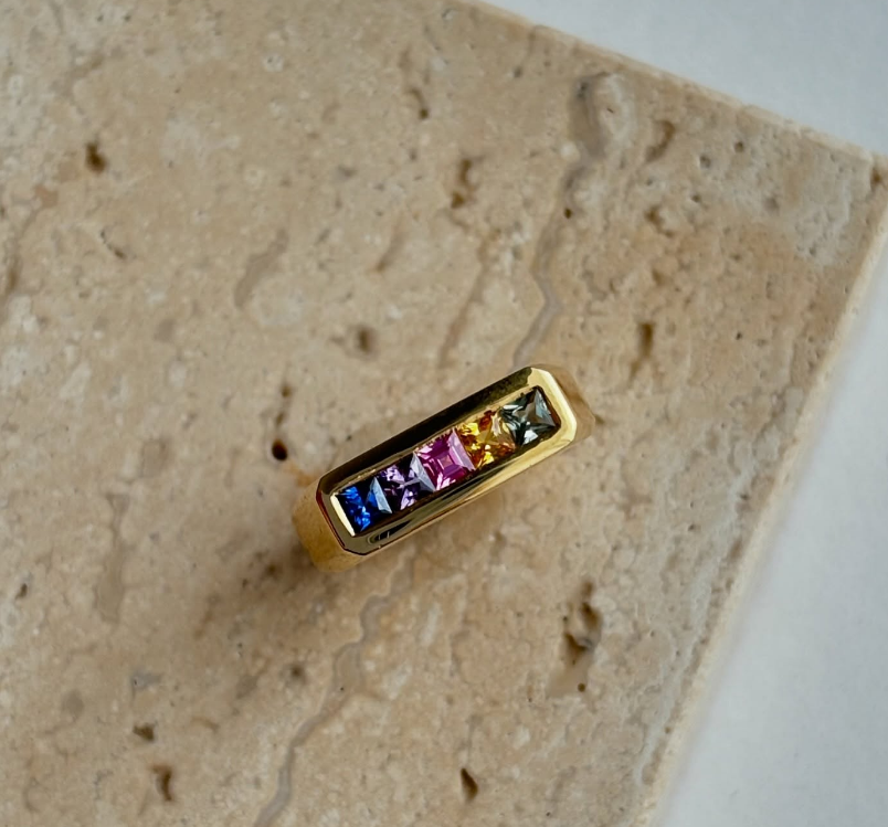 Stack of Minka Jewels Ley Lines pinky rings with rainbow sapphires in 18k yellow gold