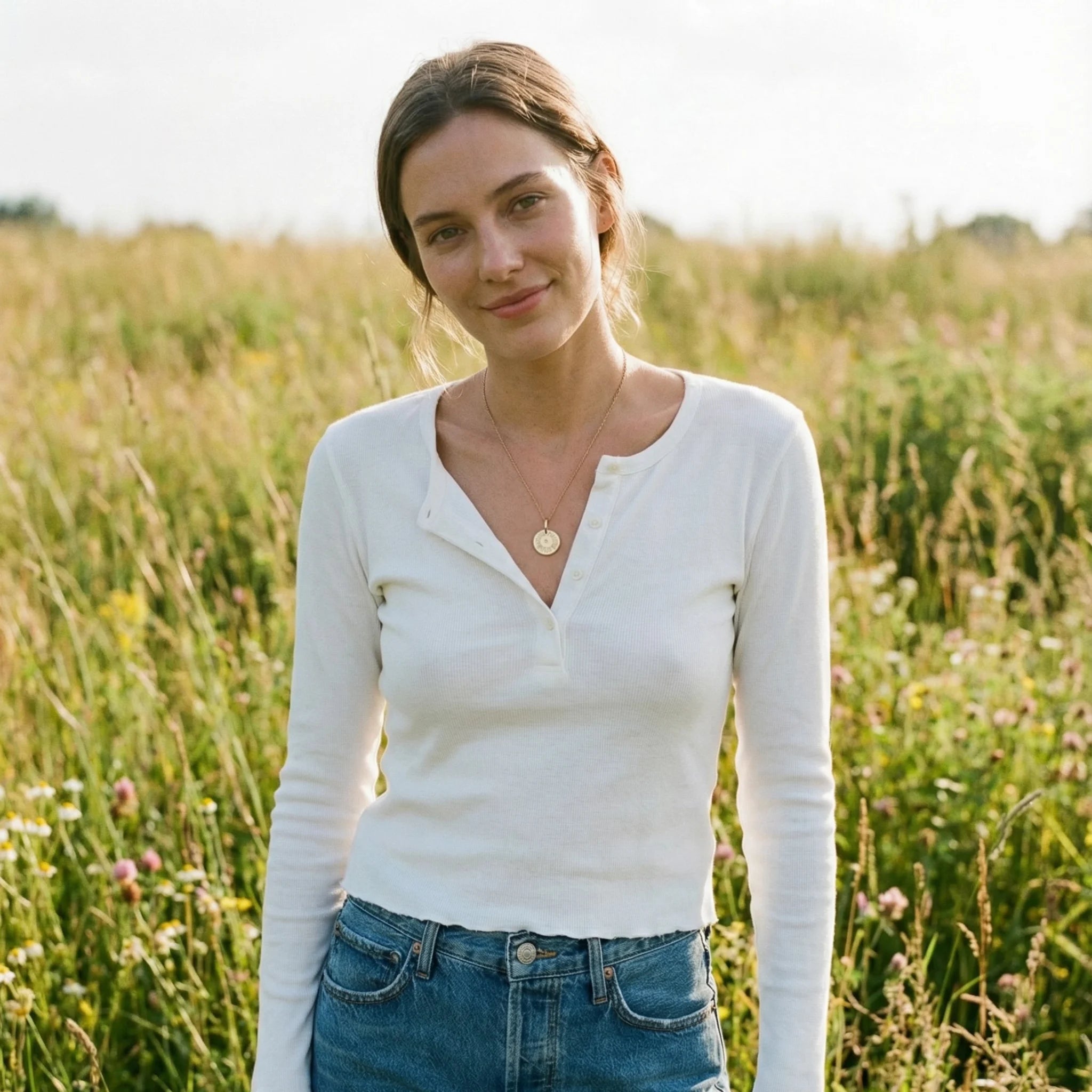 Model wearing 15mm engraved mantra disc pendant with central diamond, featuring personalized three-word mantra and year engraving, attached to a chain
