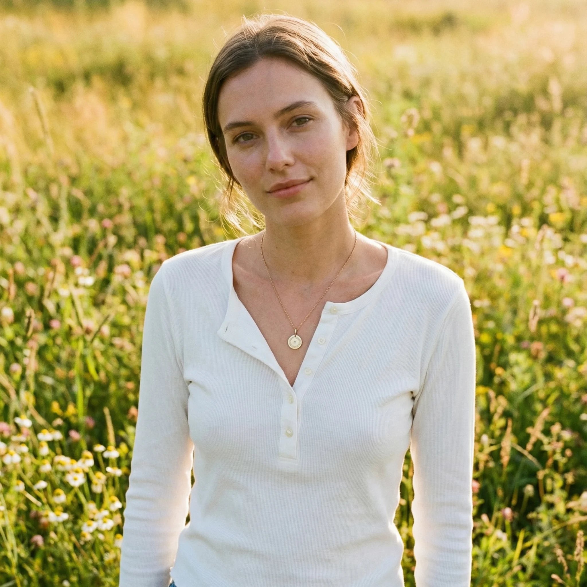 Model wearing 15mm engraved mantra disc pendant with central diamond, featuring personalized three-word mantra and year engraving, attached to a chain