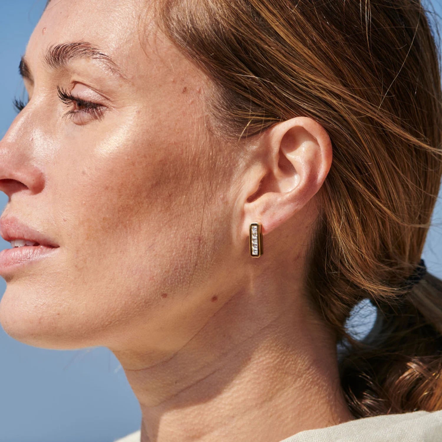 Model wearing Ley Lines Glastonbury Diamond earrings in 18k yellow gold with five carré-cut diamonds totaling 1.00ct