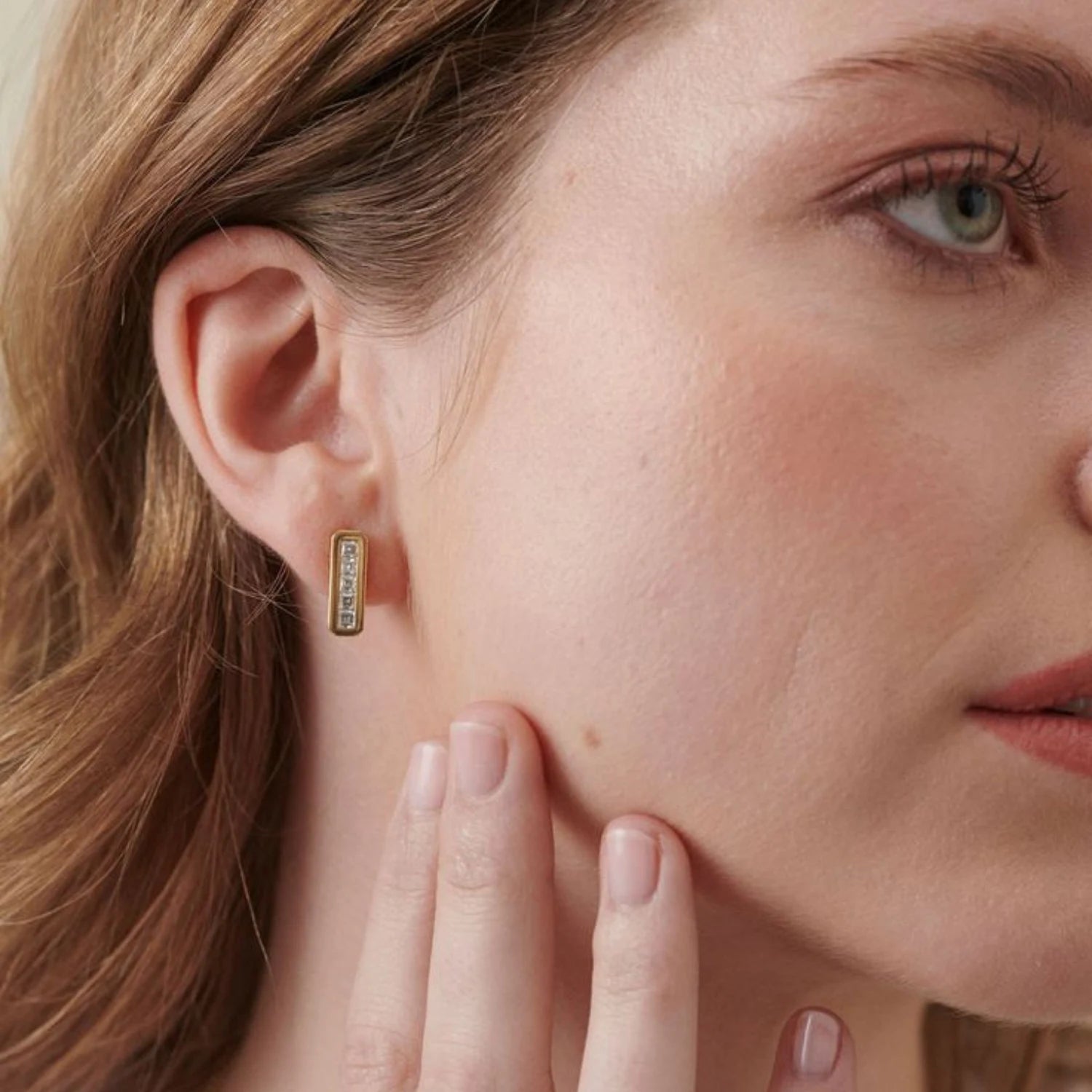 Close-up of Ley Lines Glastonbury Diamond earrings showing five carré-cut diamonds totaling 1.00ct set in 18k yellow gold