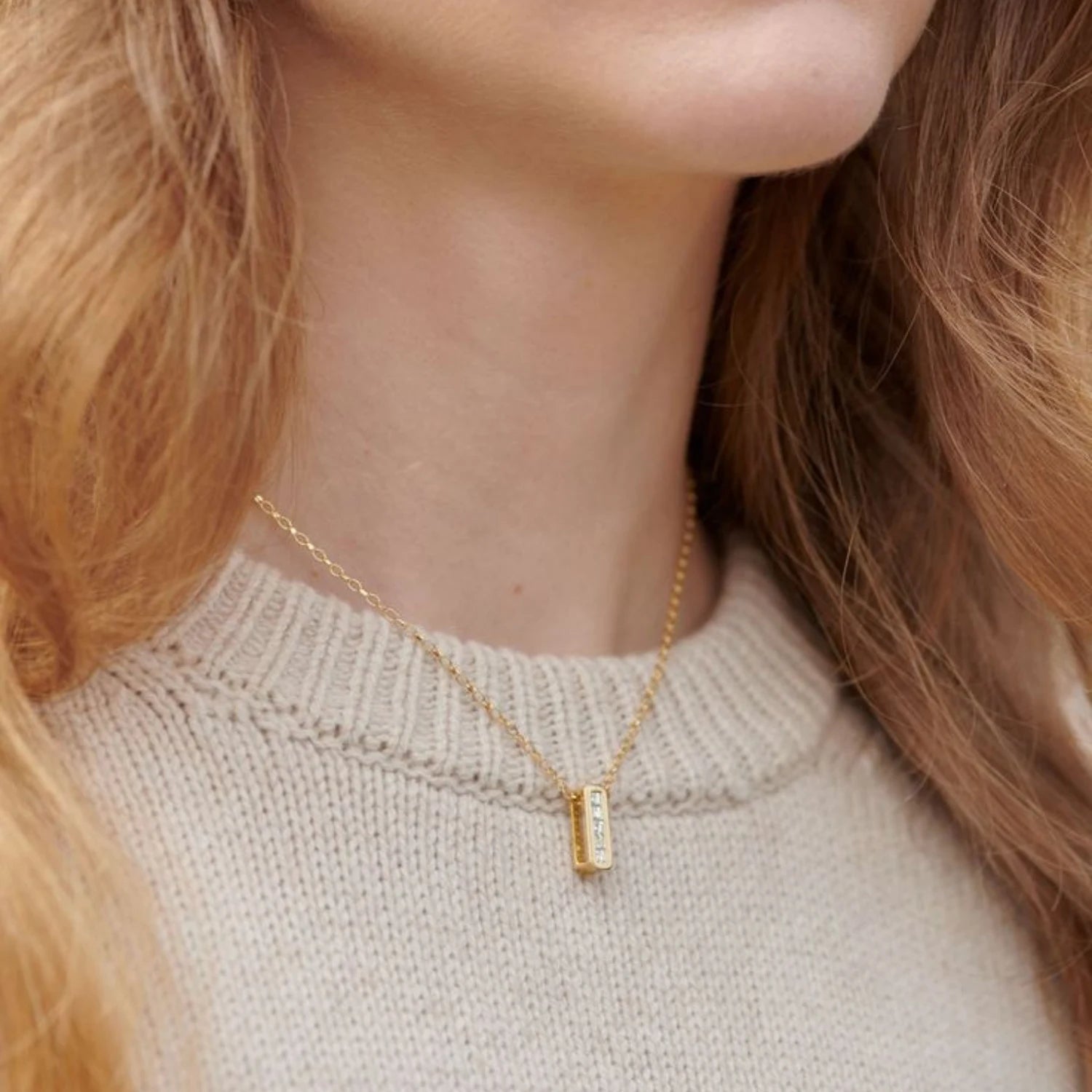 Side view of Ley Lines Glastonbury Diamond Necklace highlighting five carré-cut diamonds in 18k yellow gold setting