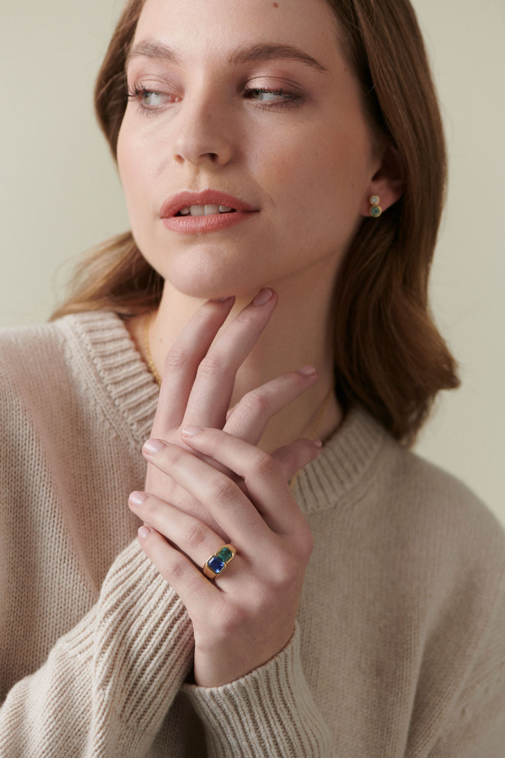 Model wearing 18k yellow gold Toi et Moi ring with sapphire and tourmaline, styled with tourmaline diamond earrings from Minka Jewels