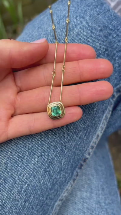 Close-up of Athena 18k yellow gold necklace showing 1.75ct green tourmaline in gold step setting